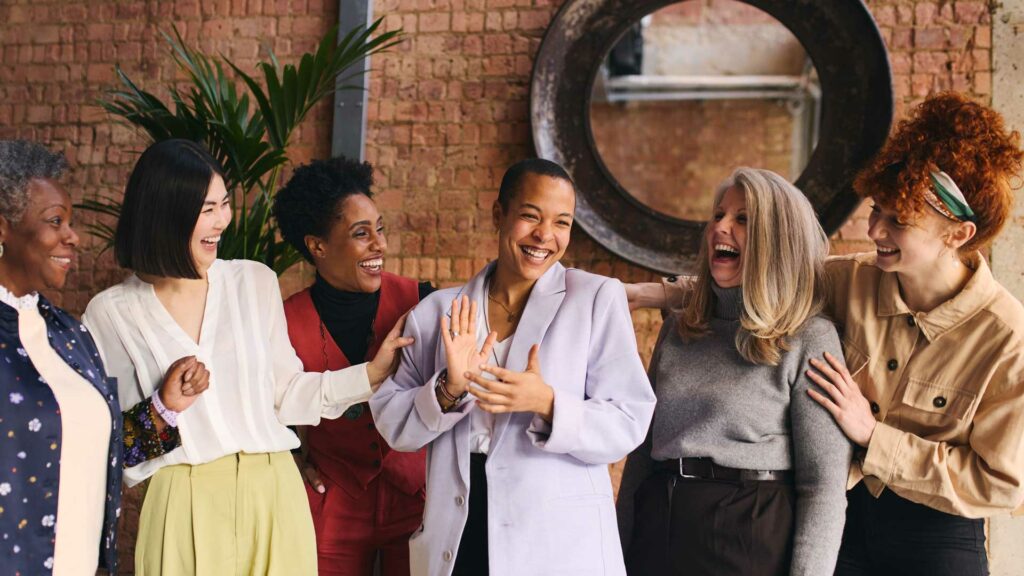 Group of business woman laughing, there is a range of ages and races